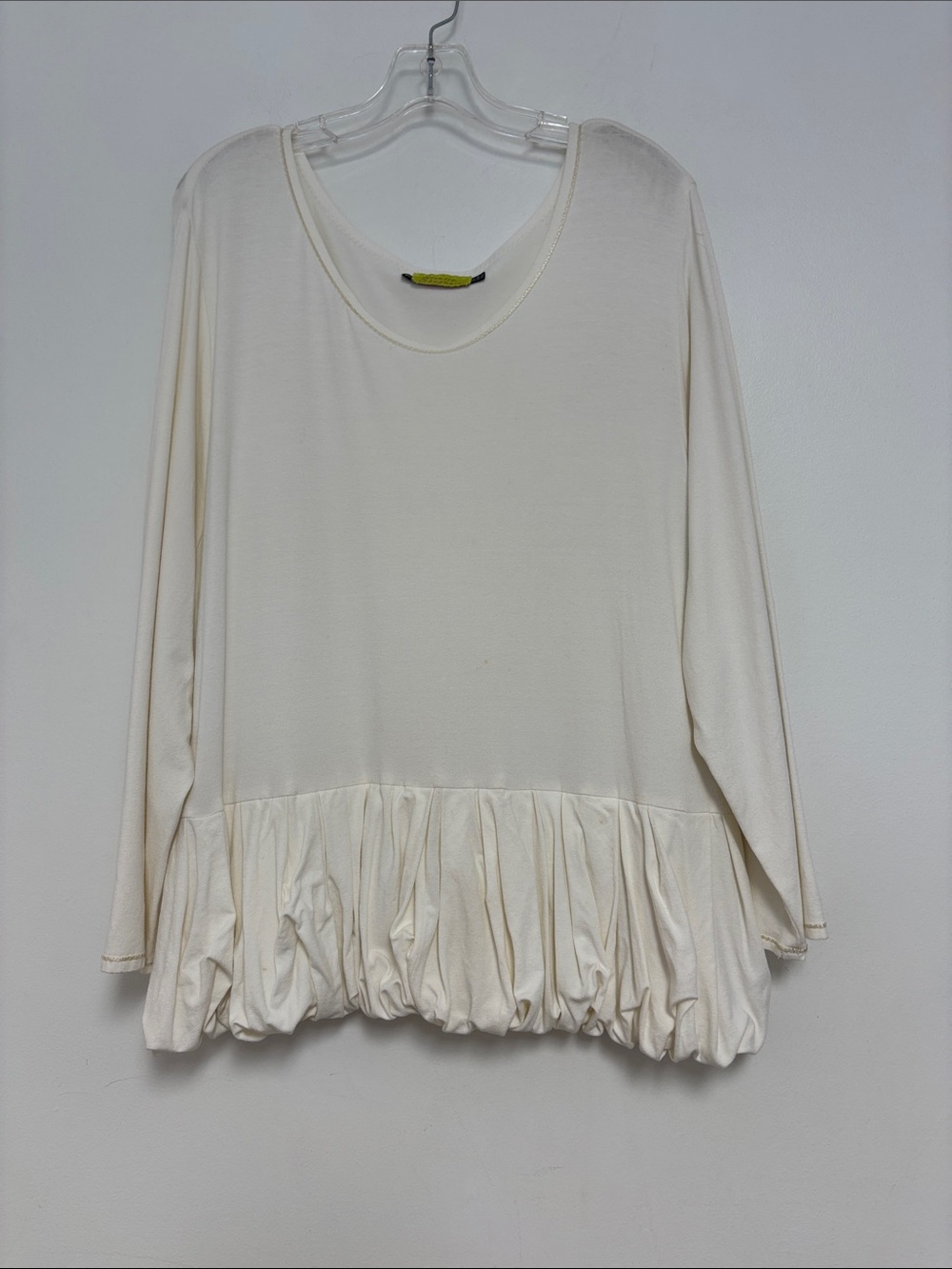 Giselle Shepatin cream, long-sleeve top with a distinctive bubble peplum hem